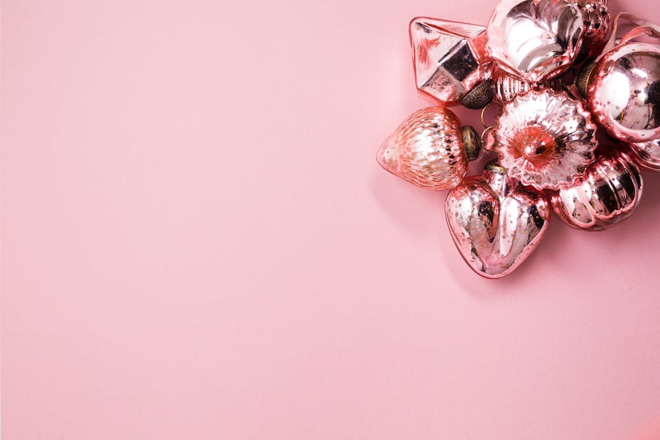 A cluster of pink Christmas ornaments on a plain background, offering elegant festive decor ideas.