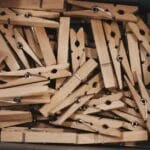 A detailed close-up of a collection of wooden clothespins in a box.