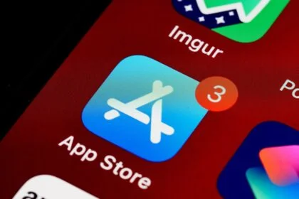 Close-up of App Store icon on iPhone screen with notification badge, highlighting app updates.