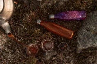 Relaxing beverages poured in nature, featuring eco-friendly bottles on rocky terrain.