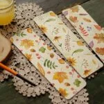 Charming handmade bookmarks featuring autumn watercolor designs, perfect for book lovers.
